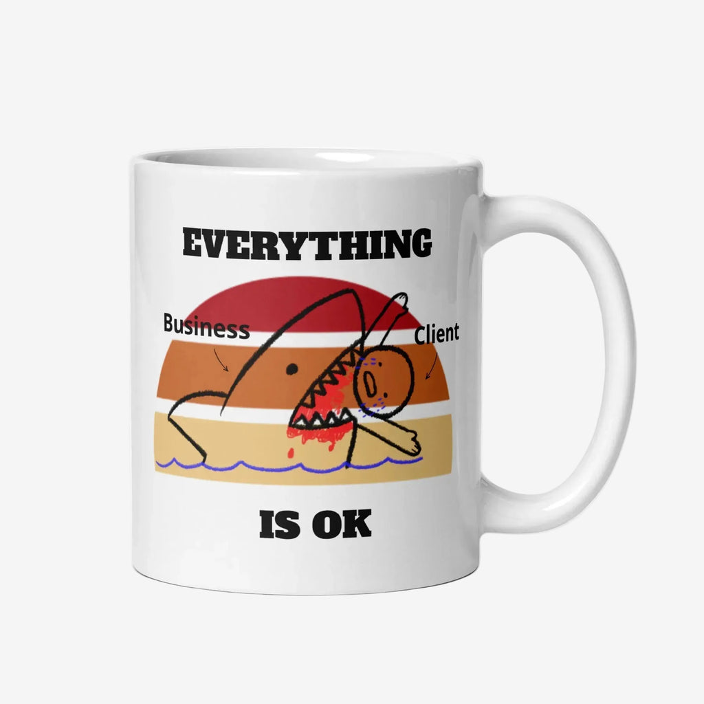 White ceramic mug with a retro sunset cartoon of a shark labeled ‘Business’ attacking a stick-figure labeled ‘Client,’ with the words ‘EVERYTHING IS OK’ above and below the image.